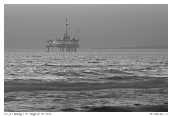 Off-shore petrol extraction  platforms, sunset. Huntington Beach, Orange County, California, USA (black and white)