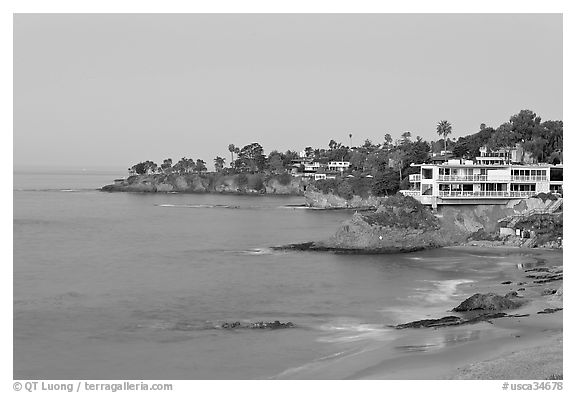 Rocky coastline with waterfront houses at dawn. Laguna Beach, Orange County, California, USA (black and white)