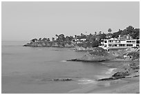 Rocky coastline with waterfront houses at dawn. Laguna Beach, Orange County, California, USA (black and white)