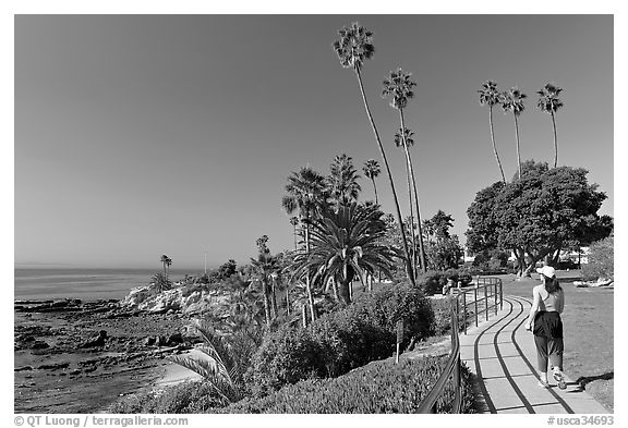 Woman jogging in Heisler Park, next to Ocean. Laguna Beach, Orange County, California, USA (black and white)
