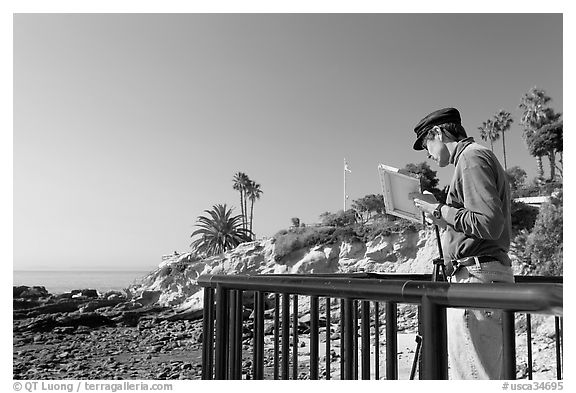 Painter working from an overlook. Laguna Beach, Orange County, California, USA (black and white)