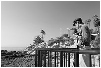 Painter working from an overlook. Laguna Beach, Orange County, California, USA ( black and white)