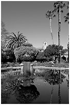 Palm trees reflected in central  courtyard basin. San Juan Capistrano, Orange County, California, USA (black and white)