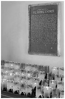 Rows of candles and sign commemorating Father Serra. San Juan Capistrano, Orange County, California, USA (black and white)