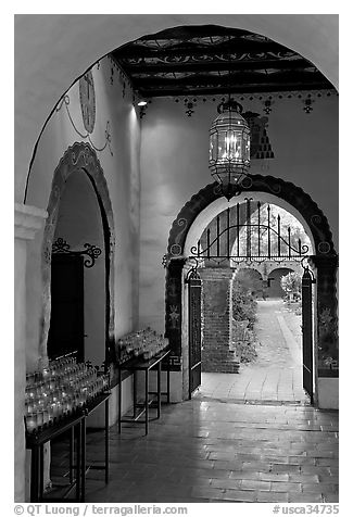 Corridor with candles next to the Serra Chapel. San Juan Capistrano, Orange County, California, USA (black and white)