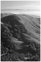 Hills, with coasline and Morro rock in the distance. Morro Bay, USA ( black and white)