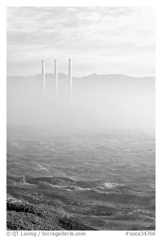 Chimneys of power plant emerging from the fog. Morro Bay, USA (black and white)