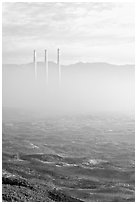 Chimneys of power plant emerging from the fog. Morro Bay, USA (black and white)