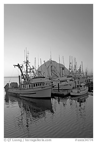 Fishing boats and Morro Rock, sunset. Morro Bay, USA