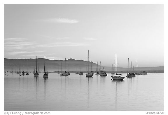 Yachts in calm Morro Bay harbor, sunset. Morro Bay, USA