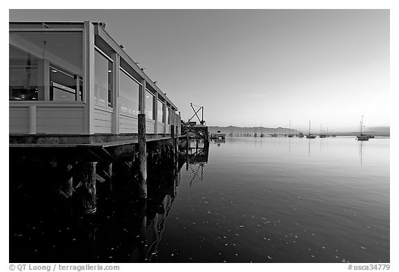 Waterfront restaurant in Morro Bay harbor, sunset. Morro Bay, USA (black and white)