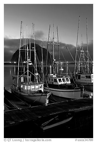 Lighted fishing boats and Morro Rock. Morro Bay, USA