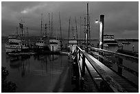 Deck and boats at night. Morro Bay, USA (black and white)