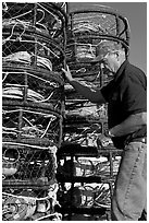 Man loading crab traps. Morro Bay, USA (black and white)