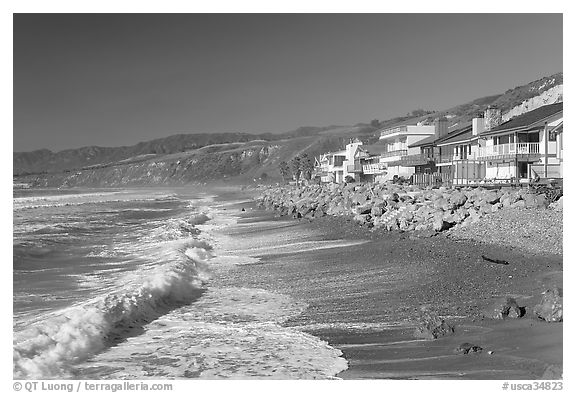 Surf and beachfront houses near Rincon Island. California, USA (black and white)