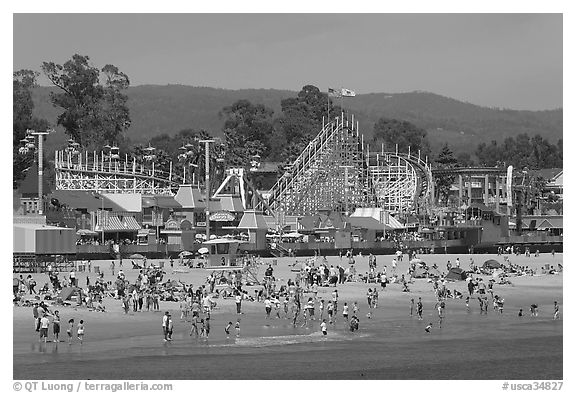 Beach and boardwalk in summer, afternoon. Santa Cruz, California, USA (black and white)