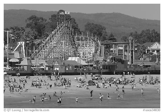 Beachgoers, and Santa Cruz boardwalk roller-coaster. Santa Cruz, California, USA