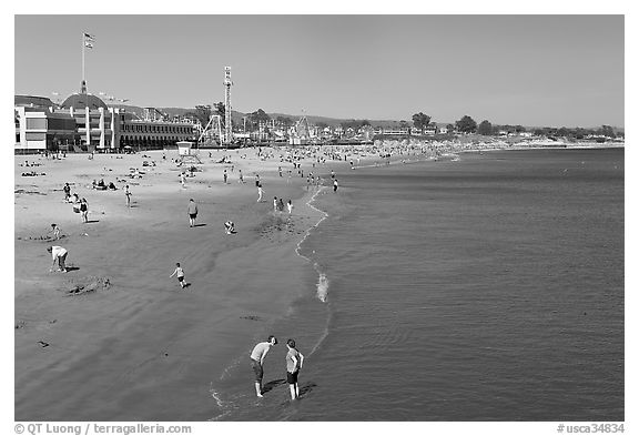 Beach with couple standing in water. Santa Cruz, California, USA