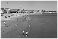 Beach with couple standing in water. Santa Cruz, California, USA (black and white)