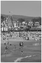 Children, beach, and boardwalk. Santa Cruz, California, USA (black and white)