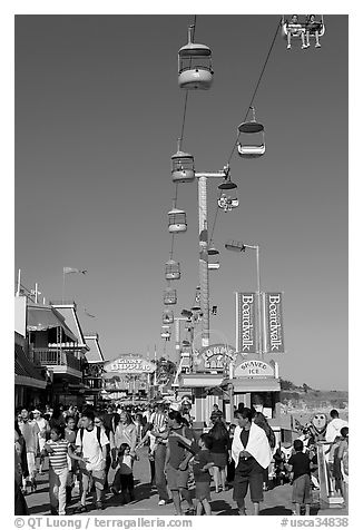 Crowd on the beach boardwalk on a summer afternoon. Santa Cruz, California, USA