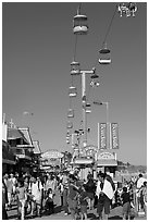 Crowd on the beach boardwalk on a summer afternoon. Santa Cruz, California, USA ( black and white)