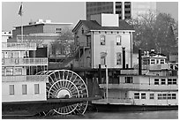 Riverboats Delta King and Spirit of Sacramento, modern and old buildings. Sacramento, California, USA (black and white)