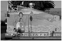 Hispanic girl on bicycle and mural, Alviso. San Jose, California, USA (black and white)