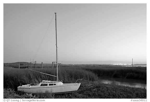 Yacht and marsh at dusk, Alviso. San Jose, California, USA