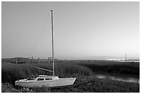 Yacht and marsh at dusk, Alviso. San Jose, California, USA (black and white)