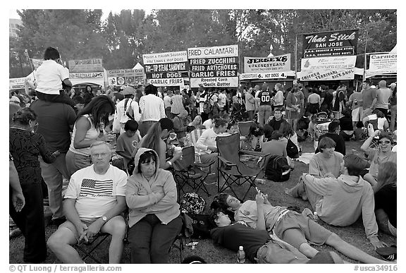 Crowd sitting on the grass in Guadalupe River Park, Independence Day. San Jose, California, USA (black and white)