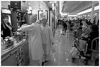 Buddhist nuns in the foot court of the Grand Century mall. San Jose, California, USA (black and white)