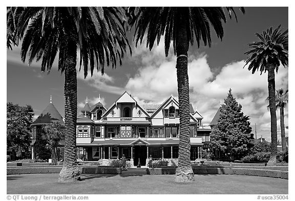 Palm trees and mansion facade. Winchester Mystery House, San Jose, California, USA (black and white)