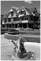 Fountain and mansion. Winchester Mystery House, San Jose, California, USA (black and white)