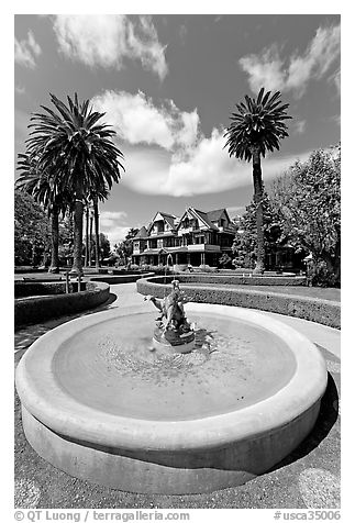 Wide view of fountain and mansion. Winchester Mystery House, San Jose, California, USA