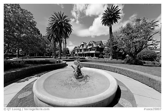 Wide view of fountain, gardens,  and mansion. Winchester Mystery House, San Jose, California, USA