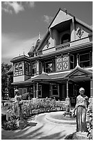 Statues, fountain, and facade. Winchester Mystery House, San Jose, California, USA (black and white)