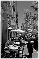 Streetside restaurant terrace and waiter. Santana Row, San Jose, California, USA (black and white)