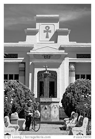 Person walking a bike, Rosicrucian Park. San Jose, California, USA (black and white)