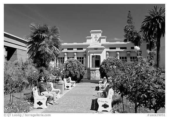 Visitor sitting on a bench, Rosicrucian Park. San Jose, California, USA (black and white)