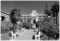 Visitor sitting on a bench, Rosicrucian Park. San Jose, California, USA ( black and white)