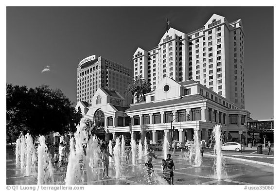 Children playing in fountain on Plaza de Cesar Chavez. San Jose, California, USA (black and white)