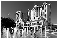 Children playing in fountain on Plaza de Cesar Chavez. San Jose, California, USA (black and white)