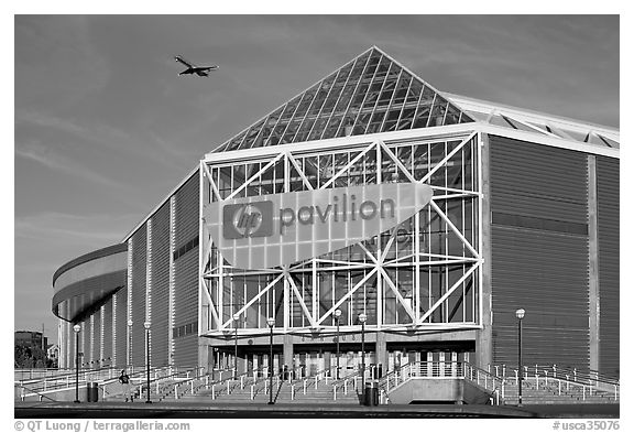 HP Pavilion with person and plane, late afternoon. San Jose, California, USA (black and white)