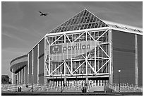 HP Pavilion with person and plane, late afternoon. San Jose, California, USA (black and white)