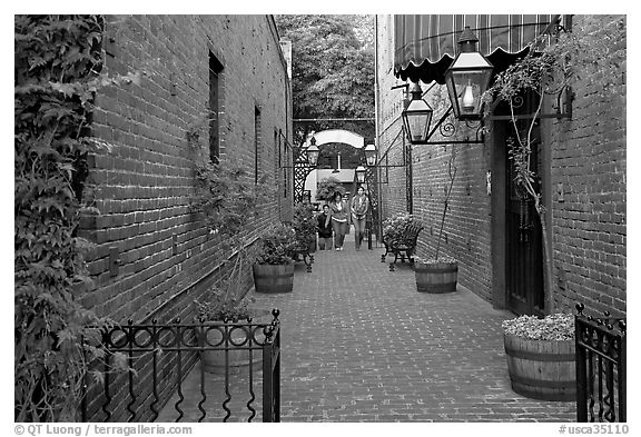 Alley with red brick walls, San Pedro Square. San Jose, California, USA (black and white)