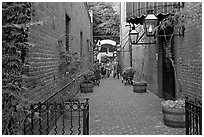 Alley with red brick walls, San Pedro Square. San Jose, California, USA (black and white)