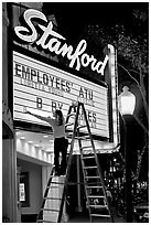 Woman changing movie title, Stanford Theatre. Palo Alto,  California, USA (black and white)