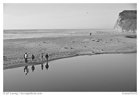 Family walking by lagoon, Scott Creek Beach. California, USA (black and white)