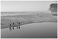 Family walking by lagoon, Scott Creek Beach. California, USA (black and white)